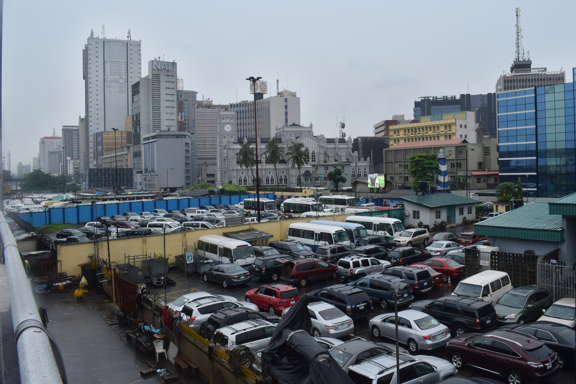Marina, Lagos Island: office towers and the cathedral above a car park, on a rainy day